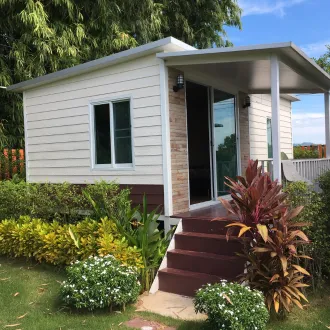 Detached ADU with front stairs entrance built by ADU Builders Dallas featuring new siding, windows, and modern roof design